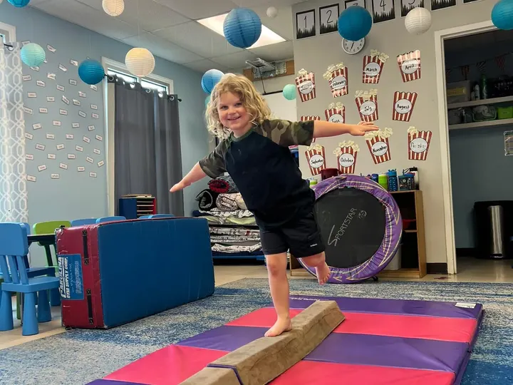 Child on the balance beam during gymnastics enrichment